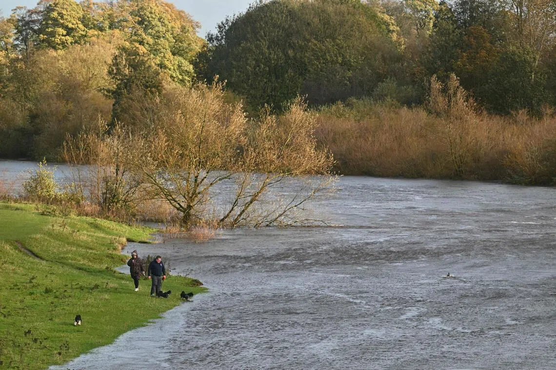 River Eden in Carlisle, north-west England, swollen on Oct 25. Hundreds of flights were cancelled or diverted because of storms across northern Europe.