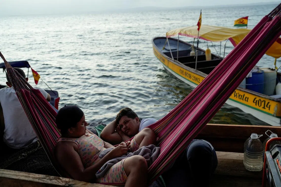 Venezuelan migrants Ysarlyn Molina and Lisbianny Amaya, who were hoping to reach the U.S. and decided to return to their country due to U.S. President Donald Trump's new immigration policies, rest as they wait for a boat to take them to the Colombian border, in Gardi Sugdub, Panama, February 23, 2025. REUTERS/Enea Lebrun