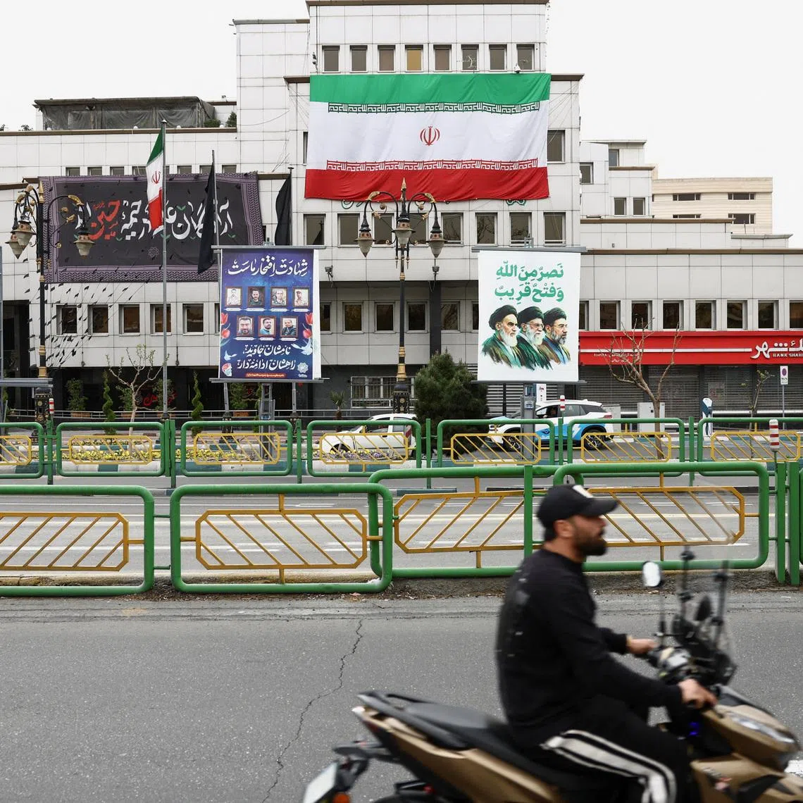 A banner with a picture of the late leader of the Islamic Revolution, Ayatollah Ruhollah Khomeini, and the late Supreme Leader of Iran, Ayatollah Ali Khamenei and Iran's new Supreme Leader, Mojtaba Khamenei, is displayed on a street, amid the U.S.-Israeli conflict with Iran, in Tehran, Iran, March 23, 2026. Majid Asgaripour/WANA (West Asia News Agency) via REUTERS