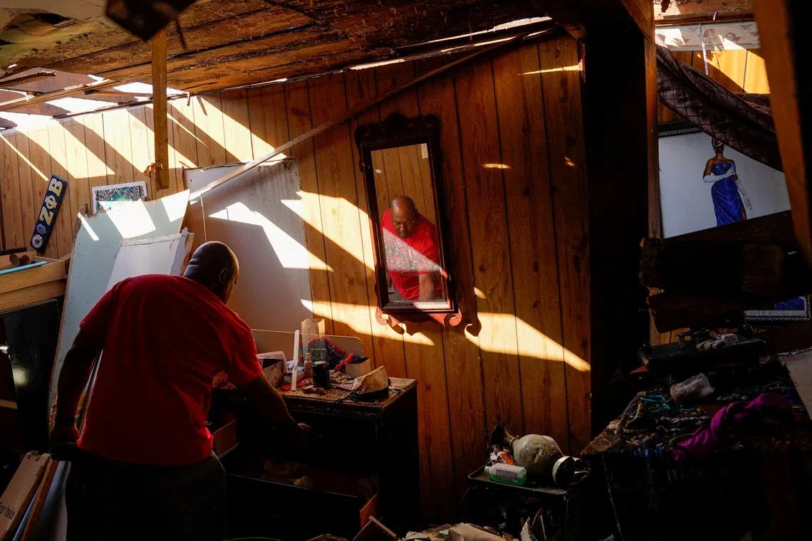 Cedric Miles, 42, searching for belongings inside his destroyed home after thunderstorms spawning high straight-line winds and tornadoes ripped across the state in Rolling Fork, Mississippi, U.S., March 25.