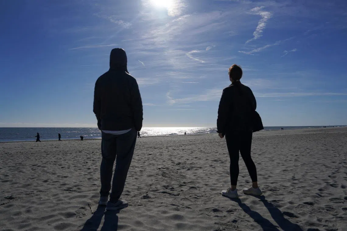 Spectators watching a Chinese balloon being shot down off the coast in Holden Beach, North Carolina, on Feb 4.