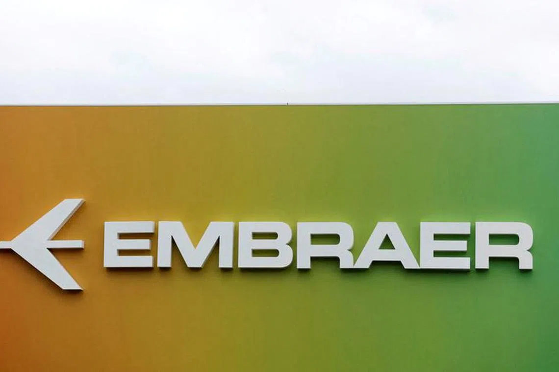 FILE PHOTO: Signage for Embraer is seen on a trade pavilion at the Farnborough International Airshow, in Farnborough, Britain, July 20, 2022.  REUTERS/Peter Cziborra/File Photo