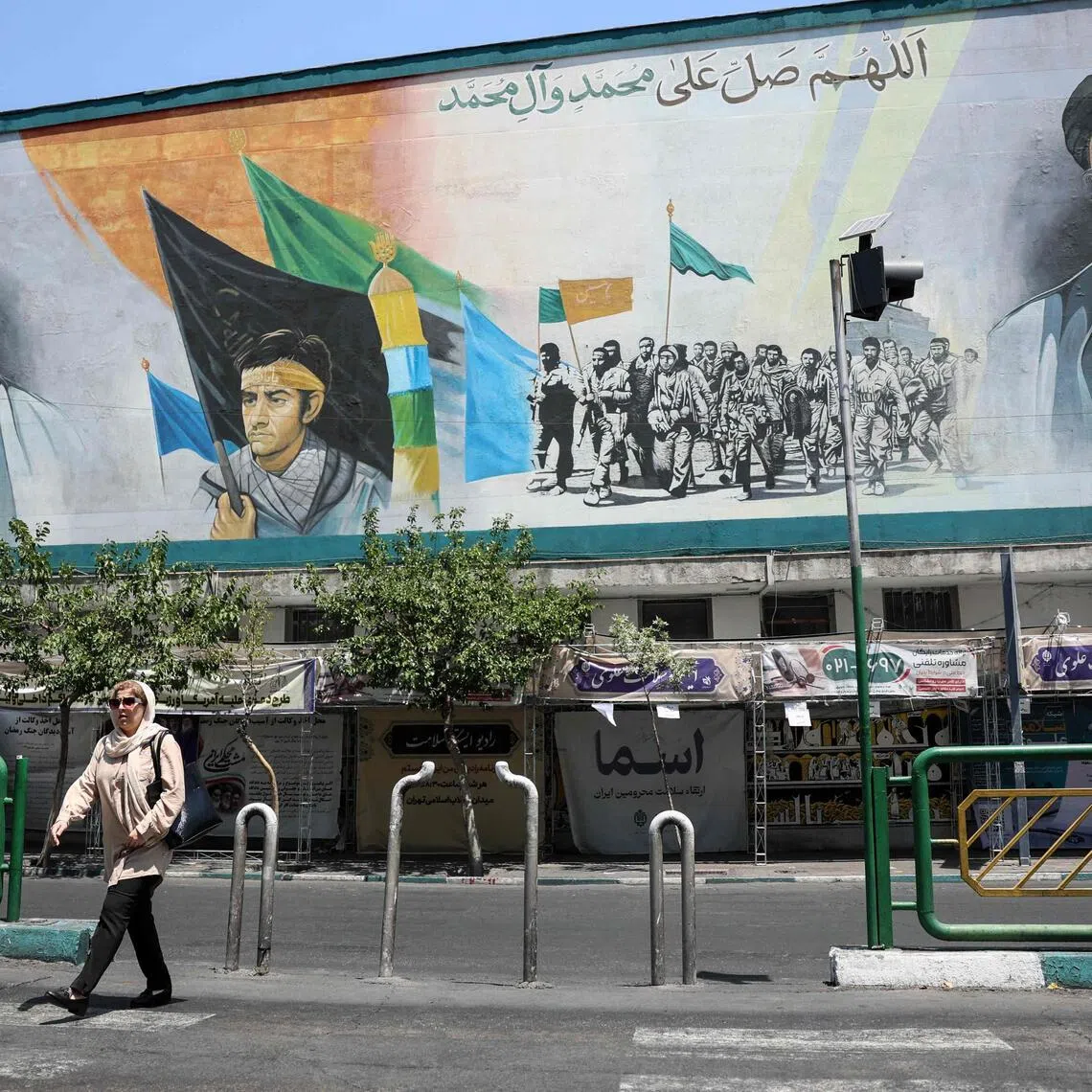 An Iranian woman walks past a mural depicting late Iranian supreme leaders Ayatollah Ali Khamenei (L) and Ayatollah Ruhollah Khomeini (R) in Tehran on June 18. The survey found that even among voters who support the right-wing bloc, the electoral base of Prime Minister Benjamin Netanyahu, 93.1 per cent believed Iran had won. 