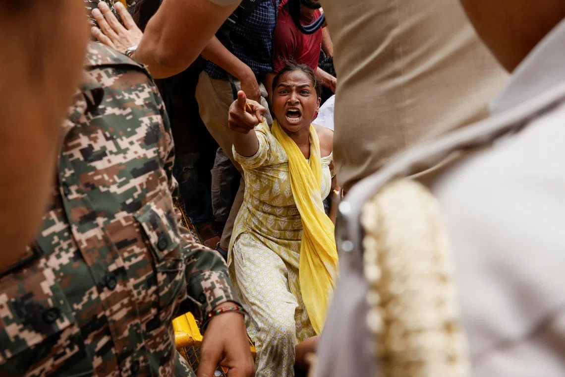 A student shouts as she protests outside the Ministry of Education against the cancellation of the UGC-NET examination at New Delhi on June 20.