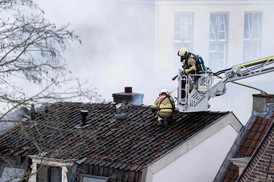 Firefighters working to extinguish a large fire at a residential house in Visscherssteeg, Utrecht, on Jan 15.