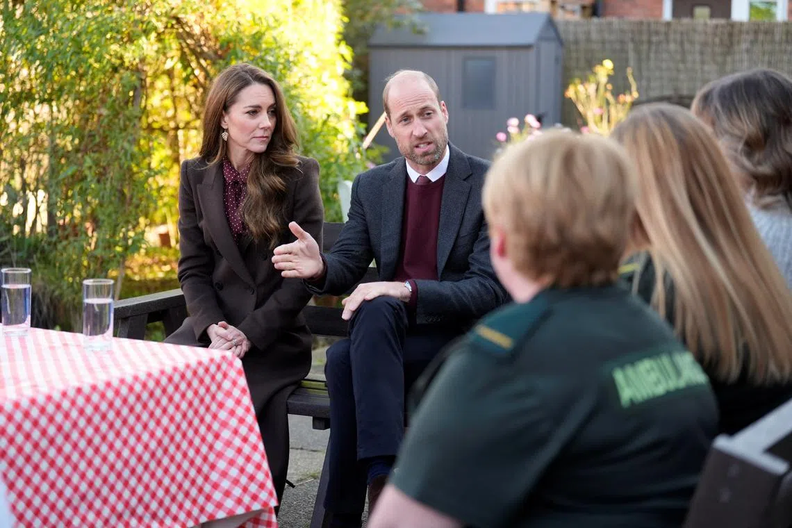 William and Catherine, the Prince and Princess of Wales, speak to members of the emergency services during a visit to Southport Community Centre.