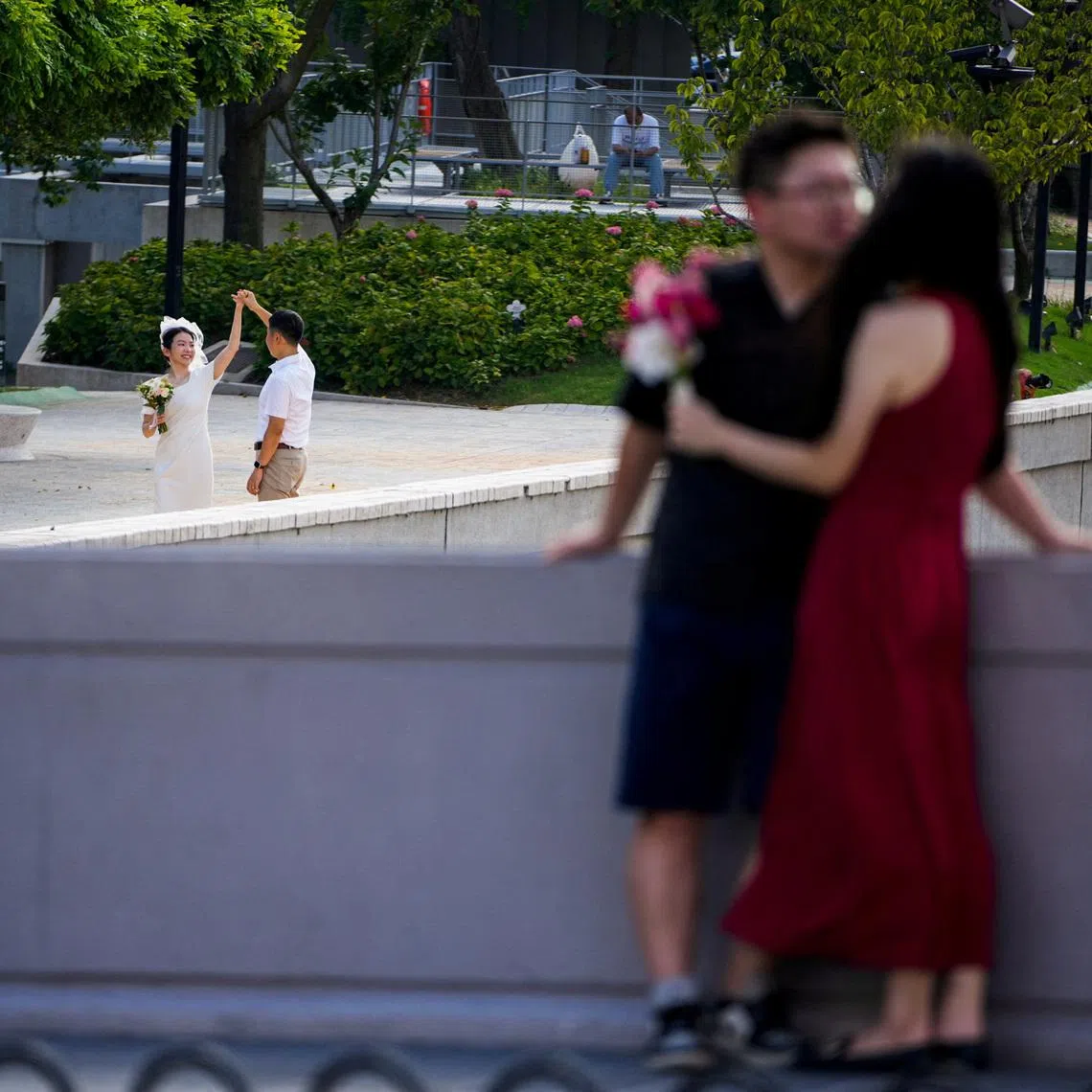 Couples prepare to get their photo taken during a wedding photography shoot on a street, in Shanghai, China September 6, 2023.
