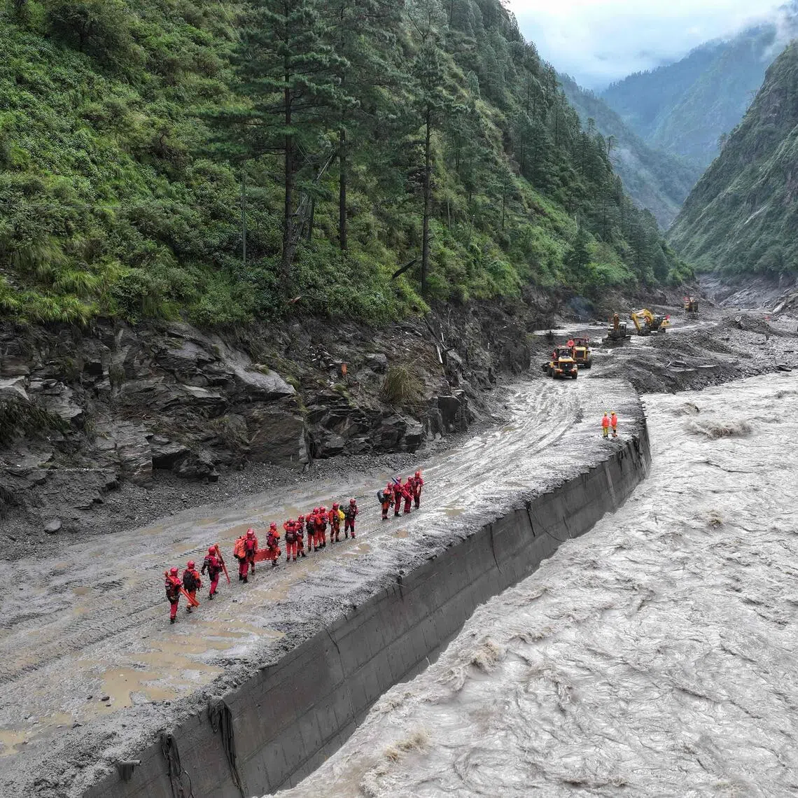 Fire and rescue personnel conduct search and rescue operations on a section of a road leading to Gyirong Port, in Gyirong County, in China’s western Tibet region on Aug 28.