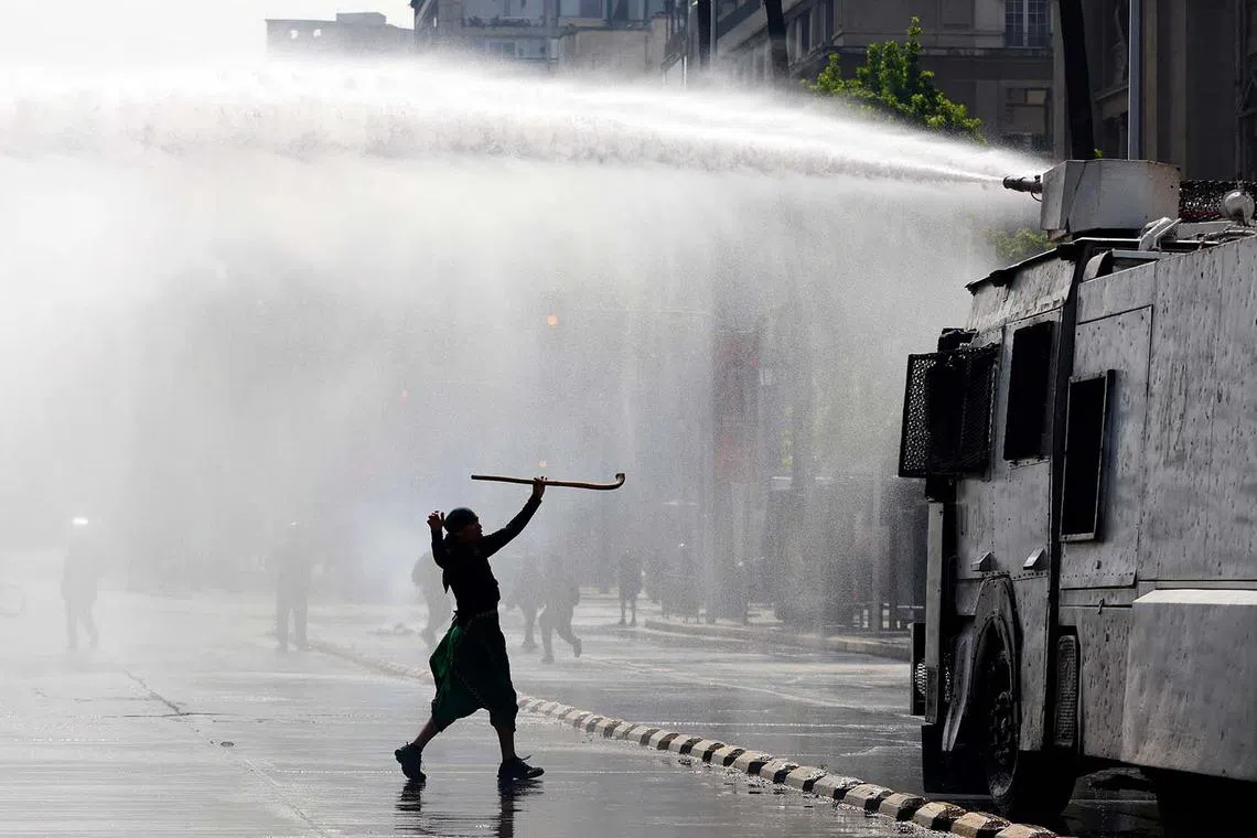 A demonstrator clashing with riot police during the march for Mapuche and all indigenous peoples' resistance in Santiago, Chile, on Oct 13, 2024.