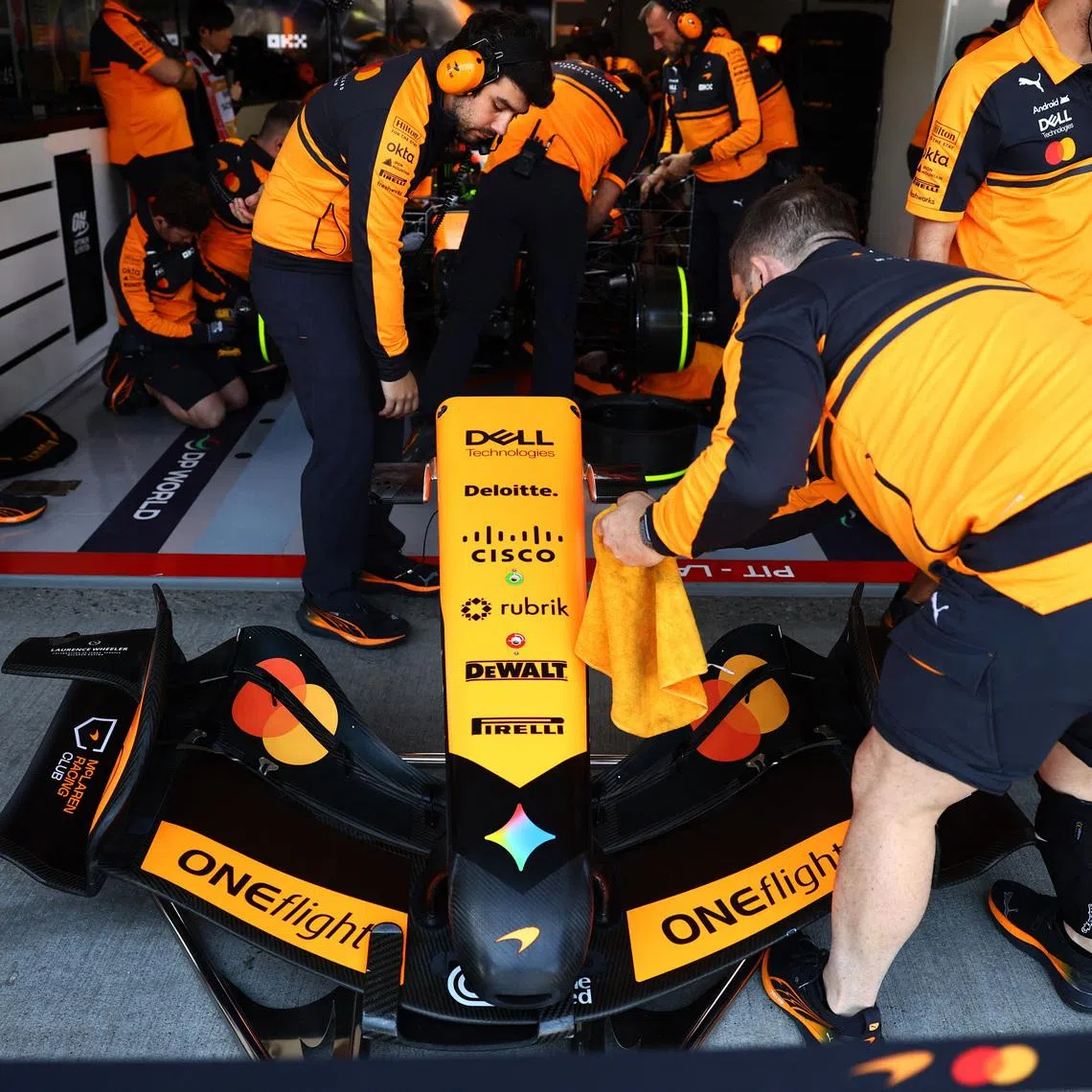 Formula One F1 - Japanese Grand Prix - Suzuka Circuit, Suzuka, Japan - March 27, 2026 An engineer works on the front wing of the car of McLaren's Lando Norris in the garage during the first practice session REUTERS/Issei Kato