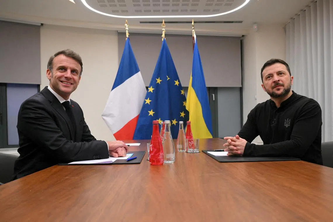 France's President Emmanuel Macron (left) and Ukraine's President Volodymyr Zelenskiy at a meeting in Brussels on Dec 18, 2024. 