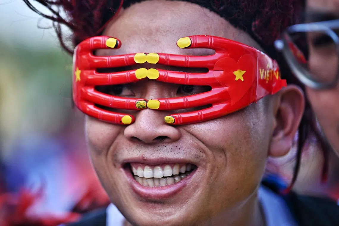 A Vietnamese supporter smiles ahead of the second leg of the AFF Cup final football match between Vietnam and Thailand at Thammasat Stadium in Bangkok on January 16, 2023.