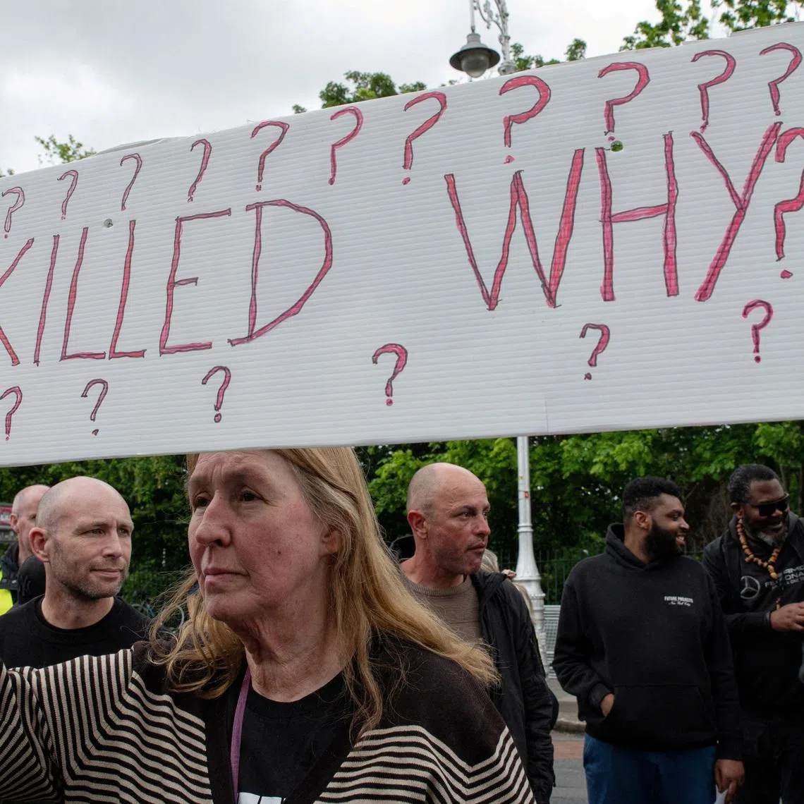 People hold placards during a protest following the death of Yves Sakila, a Congolese-born man who died after being restrained by security guards outside a department store, outside Leinster House in Dublin, Ireland, May 21, 2026. REUTERS/Natalia Campos