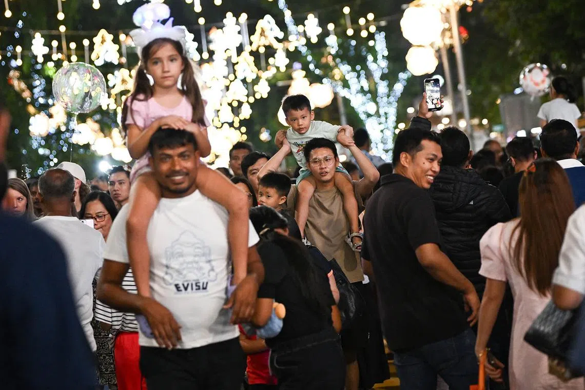 ST20241224_202430800741-Lim Yaohui-pixchristmas24/ Revellers attending for the Great Christmas Eve Street Party at Orchard Road on Dec 24, 2024. The much-anticipated Great Christmas Eve Street Party is making a triumphant return, stretching 400m from ION Orchard to Ngee Ann City. It will feature live DJ performances, roving mascots, pop-up stalls, food trucks, as well as a countdown to Christmas, among other offerings. A section of Orchard Road from Paterson Road junction to Bideford Road junction will be closed to vehicular traffic on 24 December 2024 from 6pm to 2am for revellers as the countdown to Christmas Day begins at 8pm. (ST PHOTO: LIM YAOHUI)