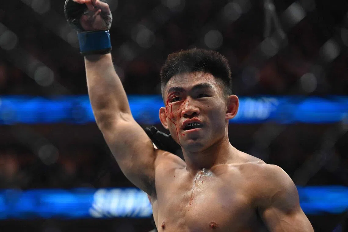 China’s Song Yadong celebrates after beating Russia’s Umar Nurmagomedov in their men’s bantamweight fight during the UFC Fight Night at Oriental Sports Center in Shanghai on Aug 29.