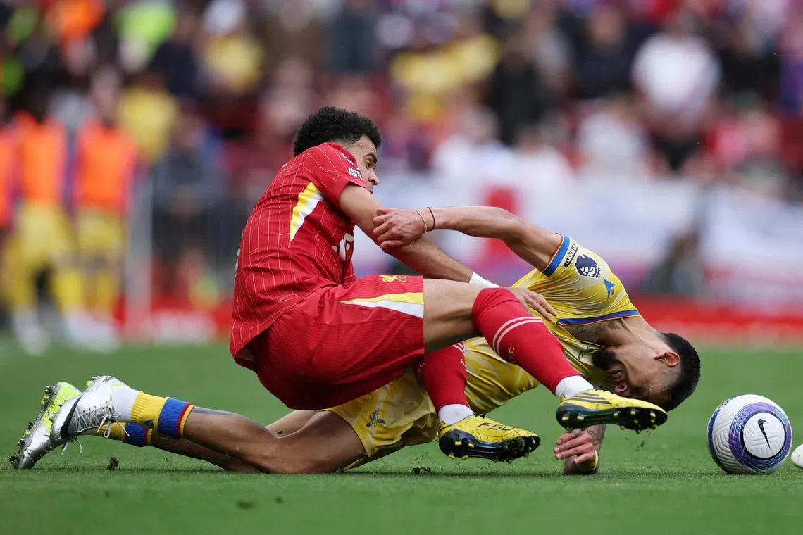 Liverpool's Luis Diaz and Crystal Palace's Daniel Munoz in action during the Premier League match between between the two clubs, held at Anfield, Liverpool, Britain, on May 25, 2025.