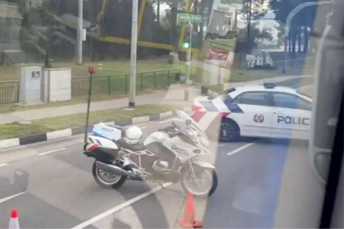 Police vehicles can be seen diverting traffic away from the accident site.
