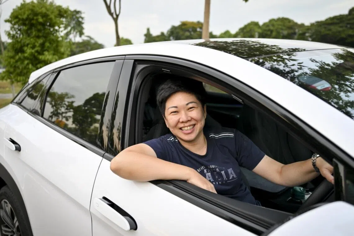 Ms Veronica Ong, 46, used to spend $600 a month on petrol. Now, she spends $150 a month charging her electric vehicle.
