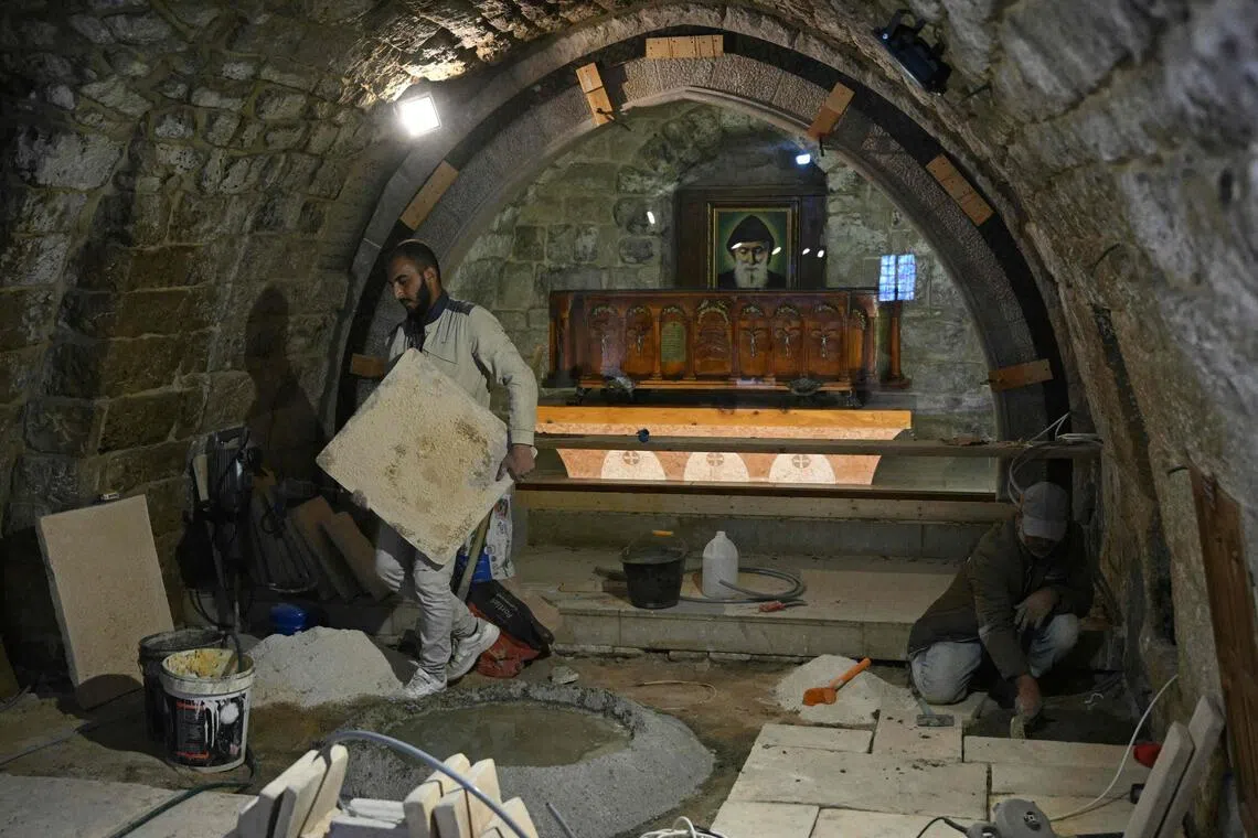 Workers renovate the floor tiles at the shrine of Saint Charbel, located within the Maronite Monastery of Saint Maron, in the mountain village of Annaya on Nov 12, 2025, in preparation for Pope Leo's visit.