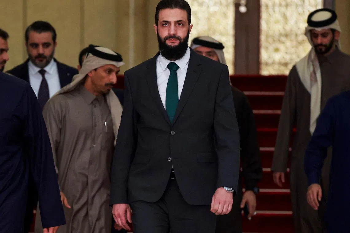 FILE PHOTO: Syria's de facto leader Ahmed al-Sharaa, also known as Abu Mohammed al-Golani, walks on the day he meets with Qatar's Minister of State Mohammed bin Abdulaziz Al-Khulaifi, after the ousting of Syria's Bashar al-Assad, in Damascus, Syria, December 23, 2024. REUTERS/Ammar Awad/File Photo
