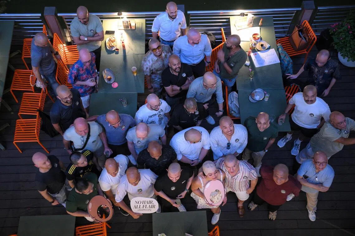Participants pose for a group photograph outside Chimi’s Especial at Collyer Quay for Singapore’s first official Bald Men Meet Up held on July 24.