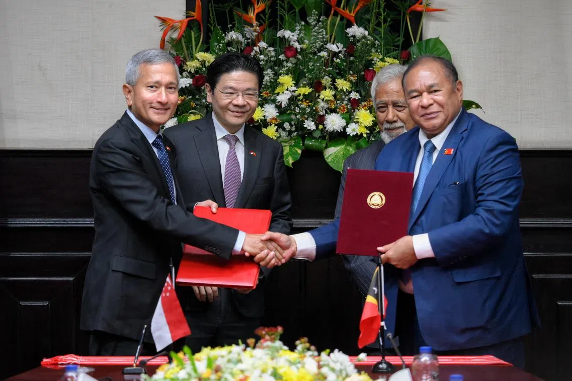Singaporean Minister of Foreign Minister Vivian Balakrishnan (far left) and Bendito dos Santos Freitas (far right), the Minister of Foreign Affairs and Cooperation of Timor-Leste, shakes hands after signing a Memorandum of Understanding on the Establishment of Bilateral Consultation, as witnessed by Prime Minister Lawrence Wong (second from left) and Timor-Leste Prime Minister Xanana Gusmao (second from right) at the Government Palace in Dili, Timor-Leste, on July 3, 2026.