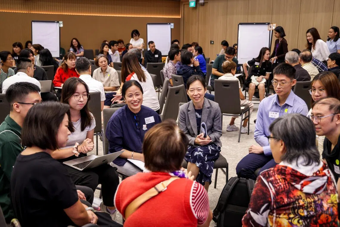 Minister of State for Education, and Digital Development and Information Jasmin Lau (in jacket) participating in a small group discussion at a public engagement session about the future of education on July 26.