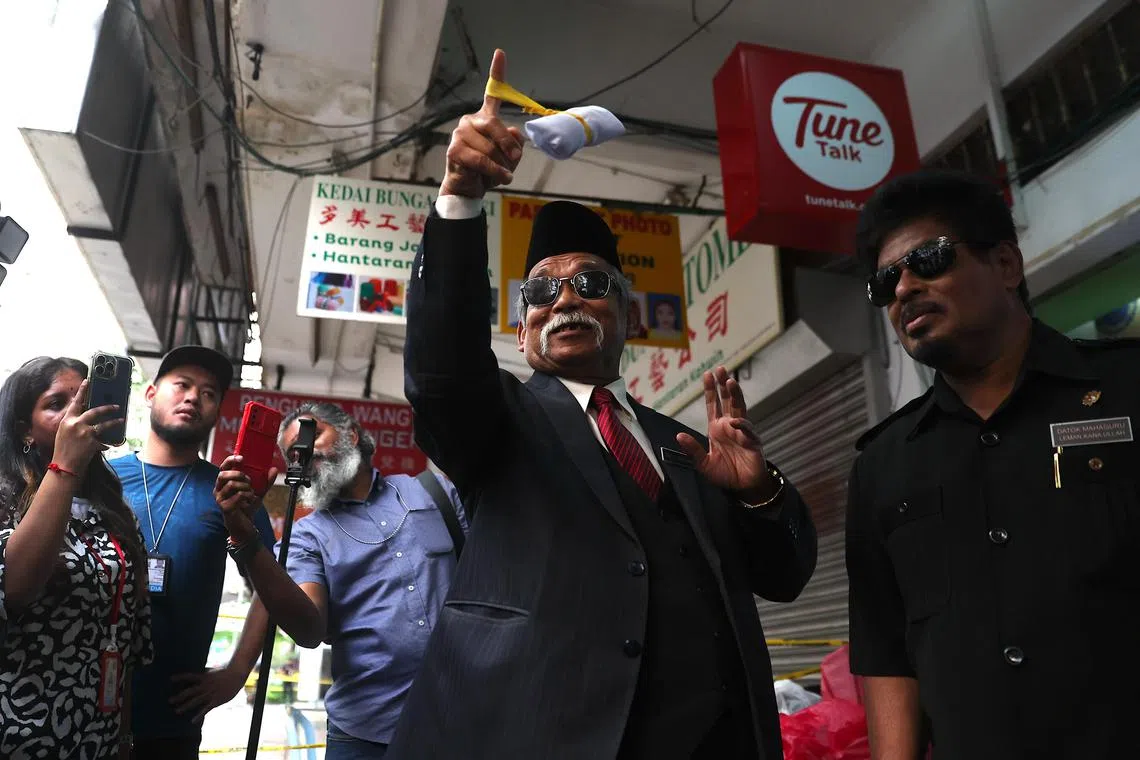 Mr Ibrahim performs a ritual near the area where an Indian woman fell into an 8m-deep sinkhole on Aug 23.
