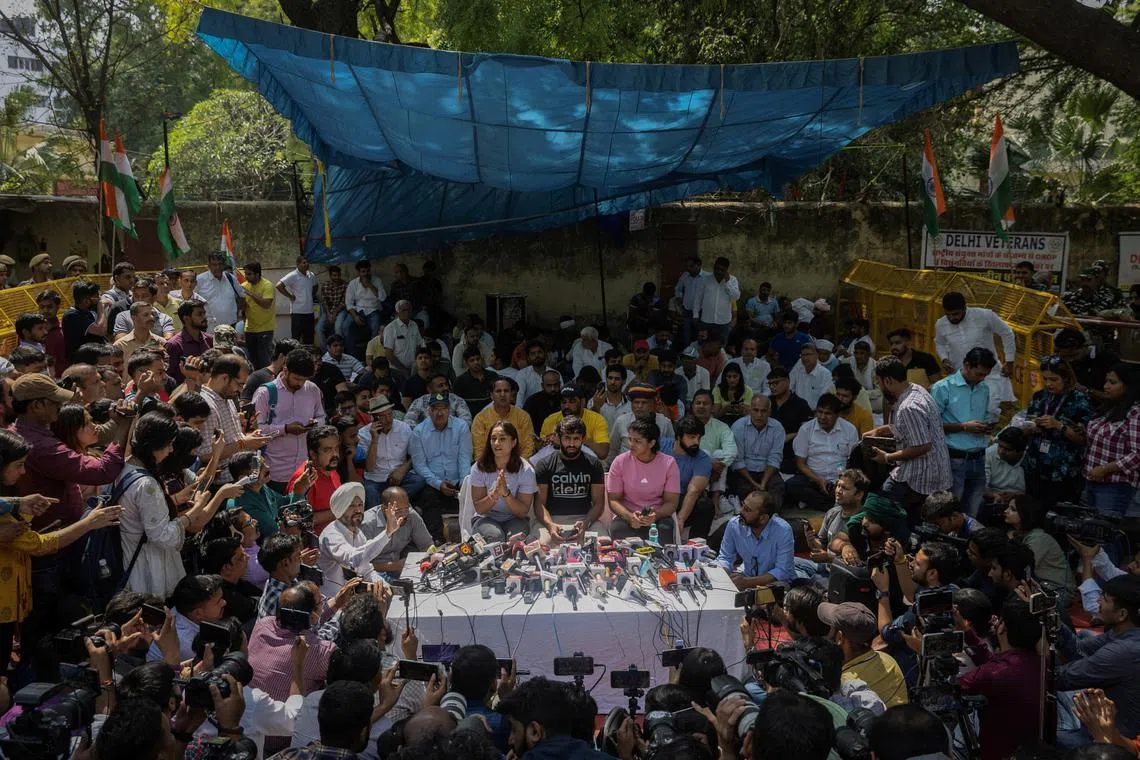 FILE PHOTO: Indian wrestlers Vinesh Phogat, Bajrang Punia, and Sakshi Malik address a news conference as they take part in a sit-in protest demanding arrest of Wrestling Federation of India (WFI) chief, who they accuse of sexually harassing female players, in New Delhi, India, April 24, 2023. REUTERS/Adnan Abidi/File Photo