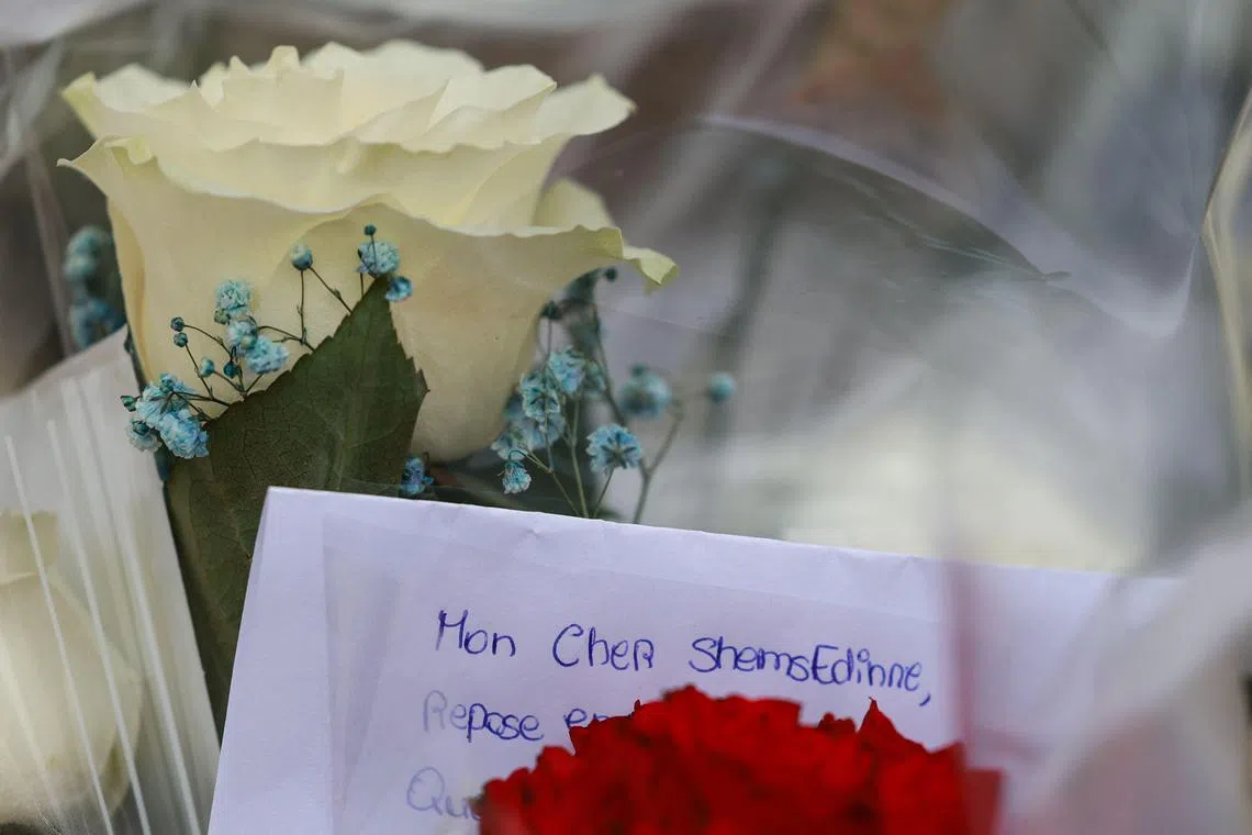 This photograph taken on April 7, 2024, shows flowers and a letter reading "My dear Shemsedinne" displayed as a tribute before the entrance of middle school Les Sablons in Viry-Chatillon, following the fatal beating of teeanage boy Shemseddine.