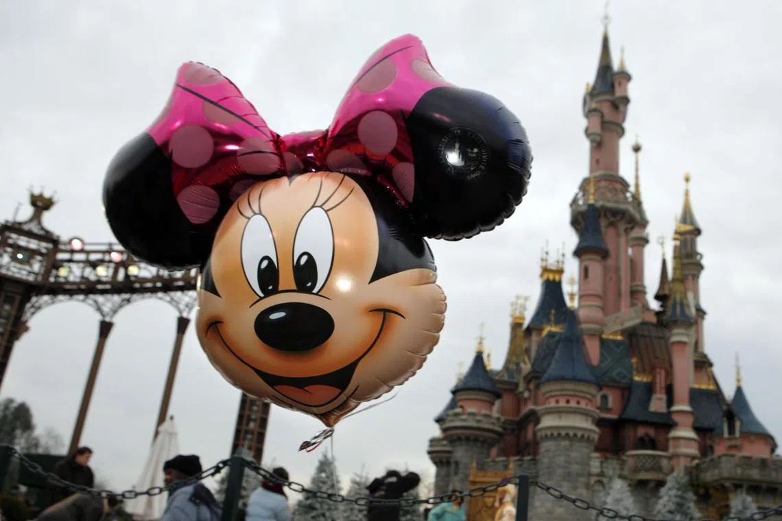 A balloon representing Minnie Mouse floats in front of Cinderella's Castle at Disneyland Resort Paris, the amusement park run by Eurodisney near Paris, France, Saturday, December 2, 2006. Photographer: Jean-Claude Coutausse/Bloomberg News.