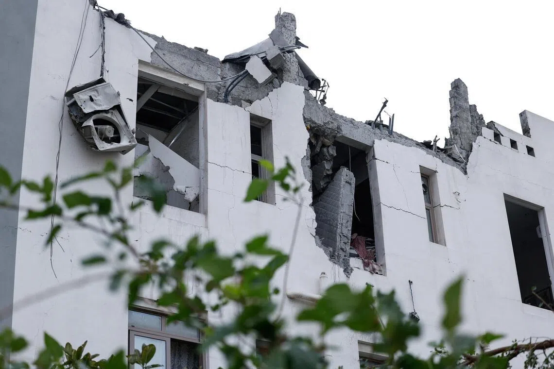 Damaged buildings at the site of an impact of what Bahrain's Ministry of Interior said was falling debris of an intercepted Iranian drone.