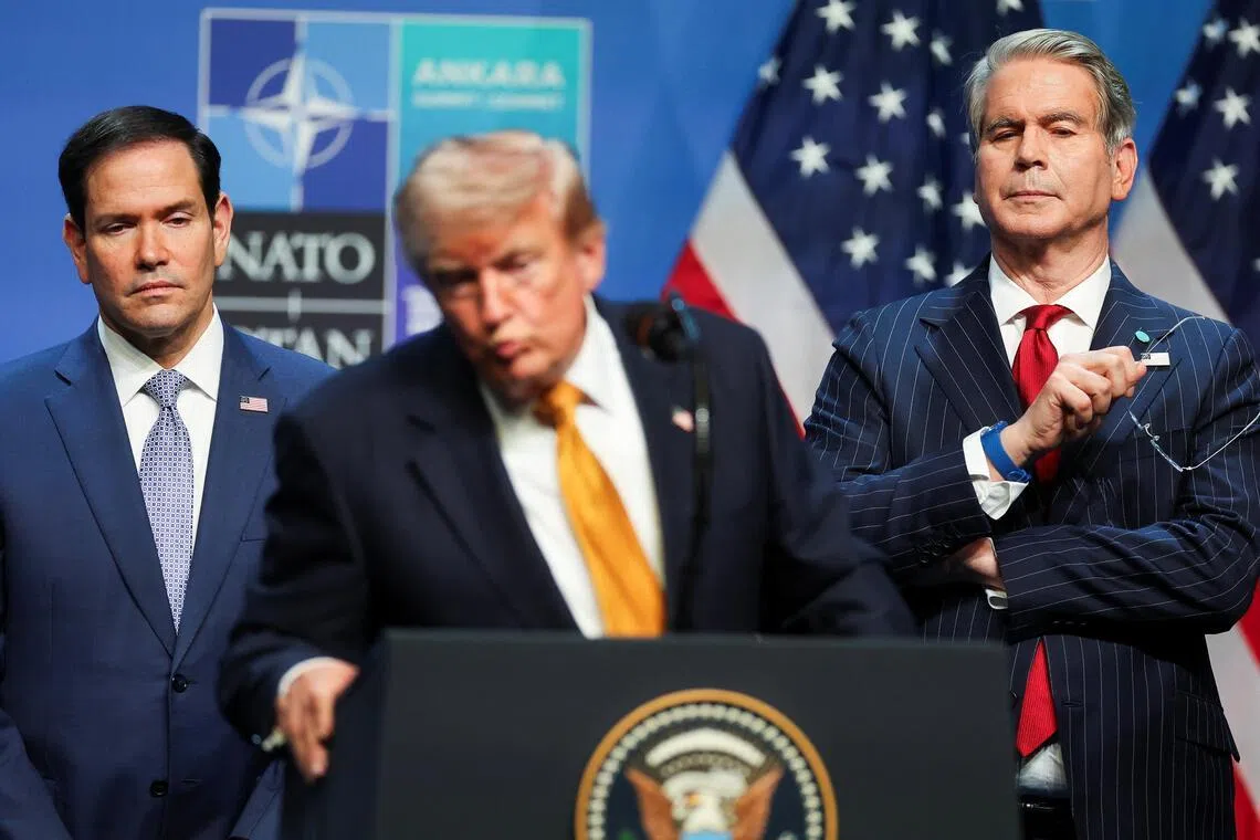 US Secretary of State Marco Rubio (left) and Treasury Secretary Scott Bessent listen as President Donald Trump speaks to the media on the sidelines of a NATO summit in Ankara on July 8.