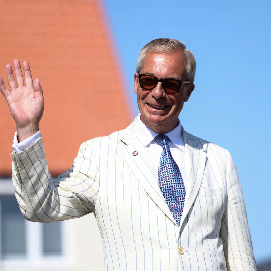 Britain's Reform UK party leader Nigel Farage arrives at his polling station for the Clacton by-election, triggered by his own resignation, in Walton-on-the-Naze, Essex, Britain, August 13, 2026. REUTERS/Toby Shepheard