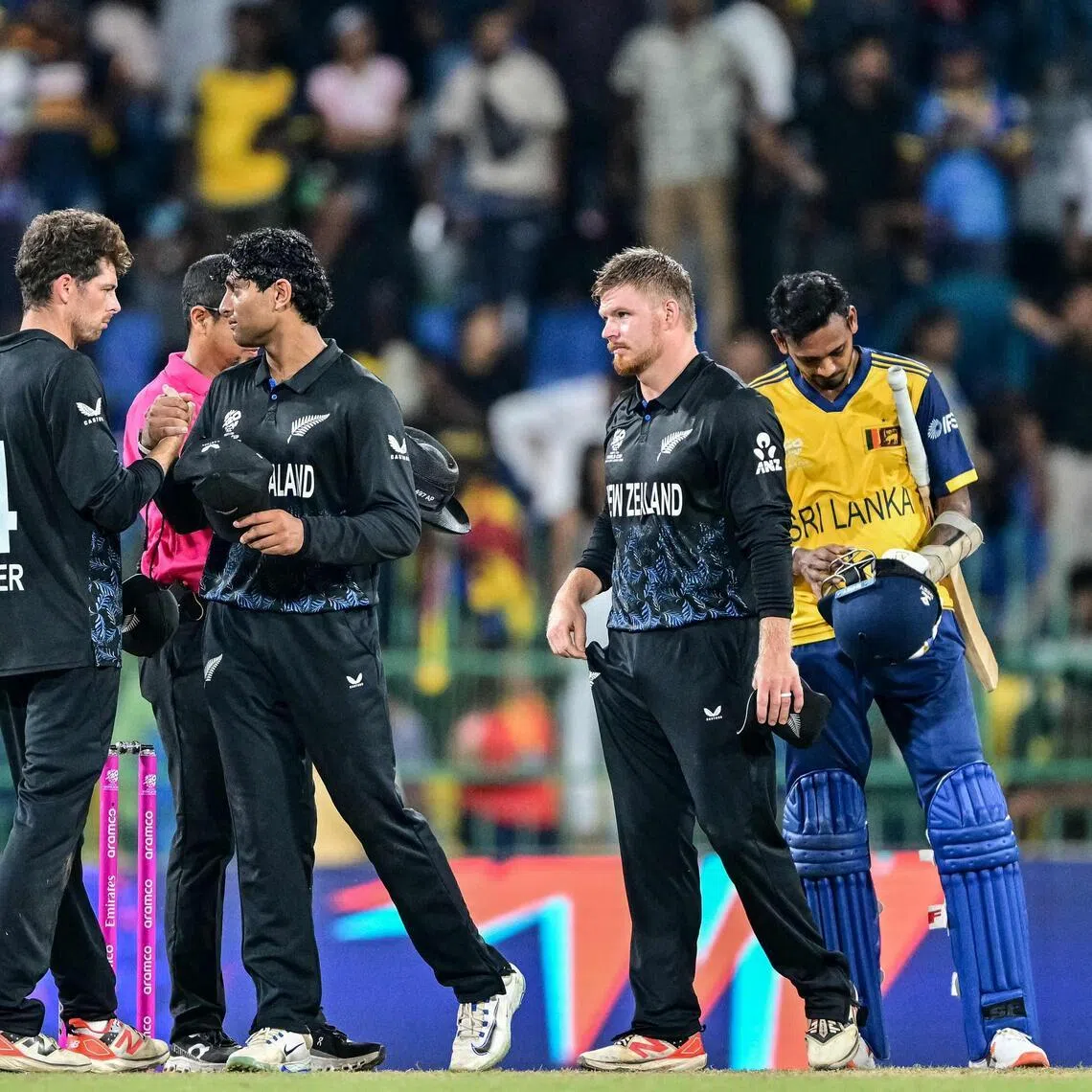 New Zealand's captain Mitchell Santner (left) and Rachin Ravindra celebrating their team's win over co-hosts Sri Lanka in the ICC Men's T20 Cricket World Cup Super Eights at the R. Premadasa Stadium in Colombo on Feb 25, 2026.