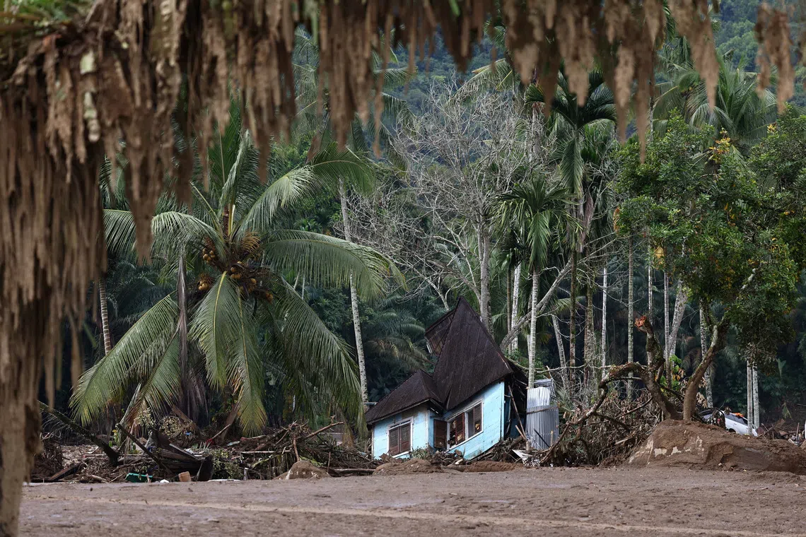 A heavily damaged house sits among debris in an area hit by deadly flash floods following heavy rains in Palembayan, Agam regency, West Sumatra province, Indonesia, December 2, 2025. REUTERS/Willy Kurniawan