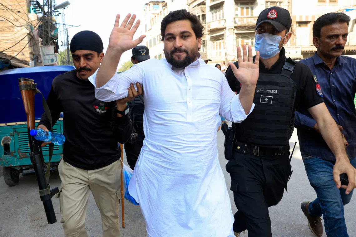Police officers detain a protester following a protest call by supporters of jailed former Pakistani Prime Minister Imran Khan's party, Pakistan Tehreek-e-Insaf (PTI), a day after Pakistan imposed a state of emergency in Khyber Pakhtunkhwa province and suspended the provincial government led by Khan's party, in Peshawar, Pakistan, October 12, 2026. REUTERS