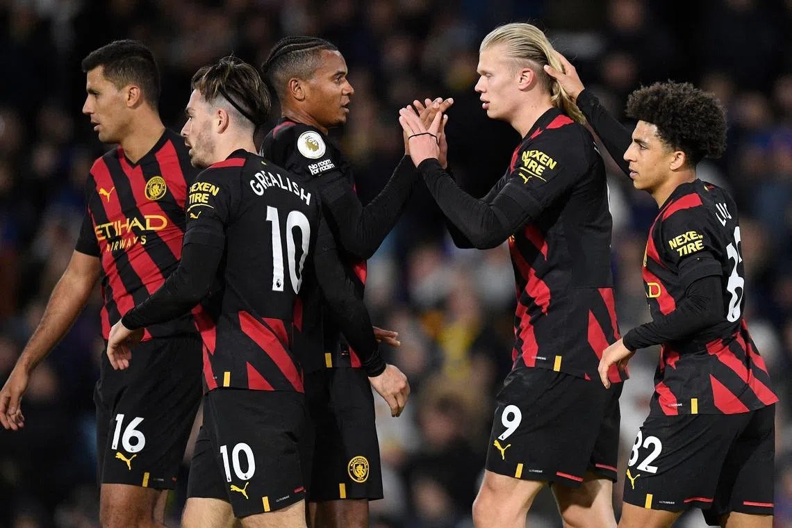 City's Norwegian striker Erling Haaland (second from right) celebrates scoring his team's third goal with teammates.