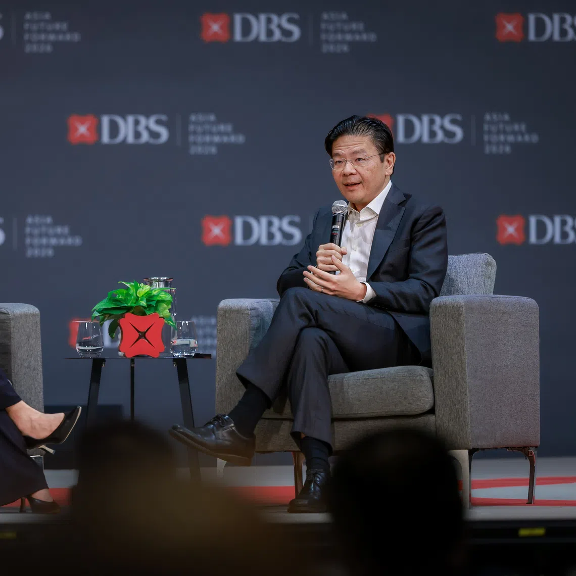 Prime Minister Lawrence Wong (right) participates in a dialogue moderated by DBS Bank CEO Tan Su Shan during the DBS Asia Future Forward Conference at Suntec Convention and Exhibition Centre on Oct 12.