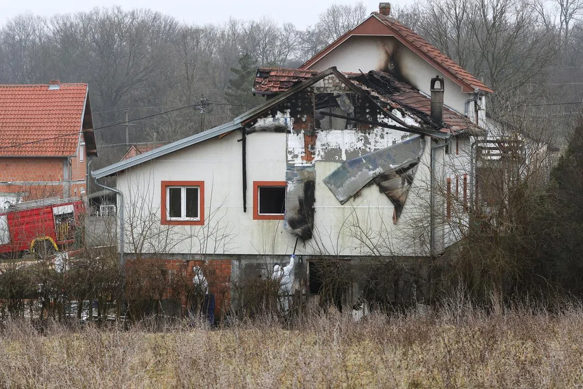 Emergency personnel work at a damaged nursing home that caught fire, outside Belgrade, Serbia, January 20, 2025. REUTERS/Djordje Kojadinovic