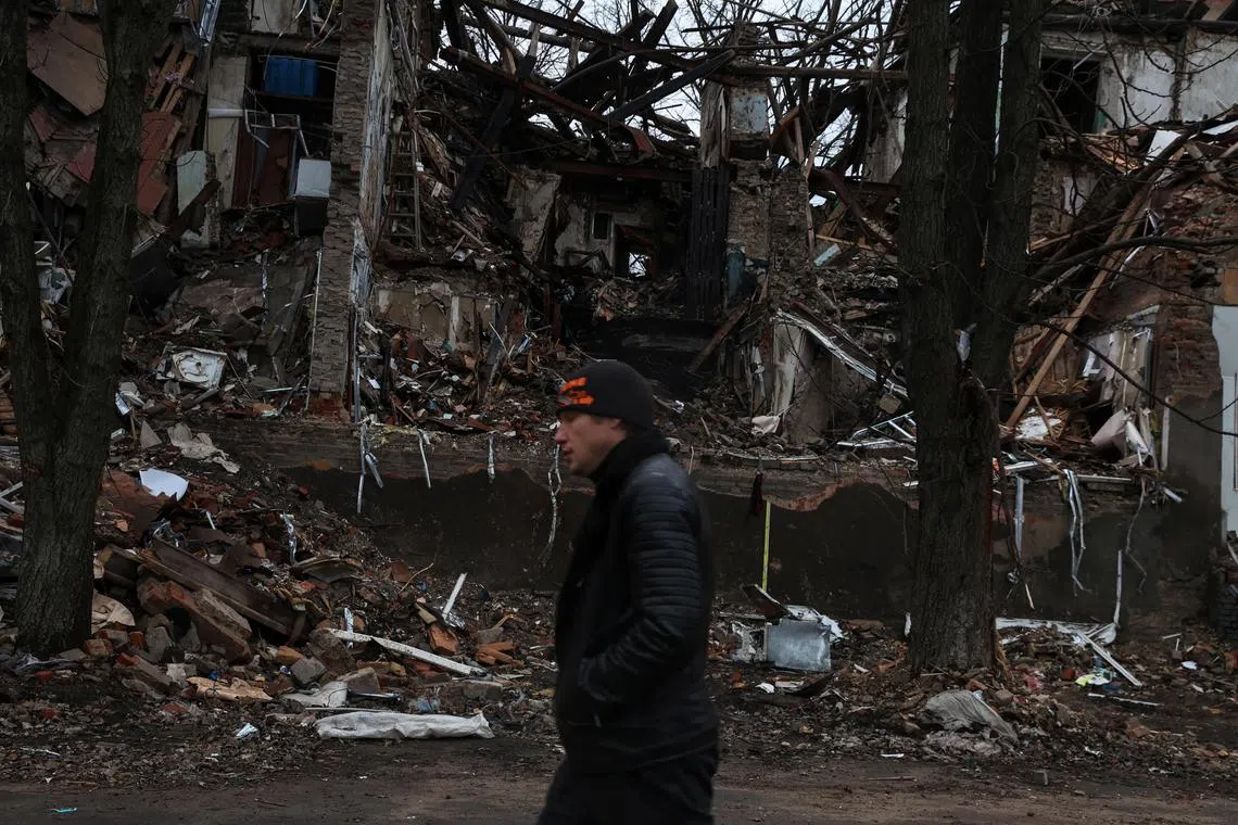 A man walking down a war-torn street in the city Slovyansk in the Donetsk region of Ukraine, on Dec 12, 2022. 