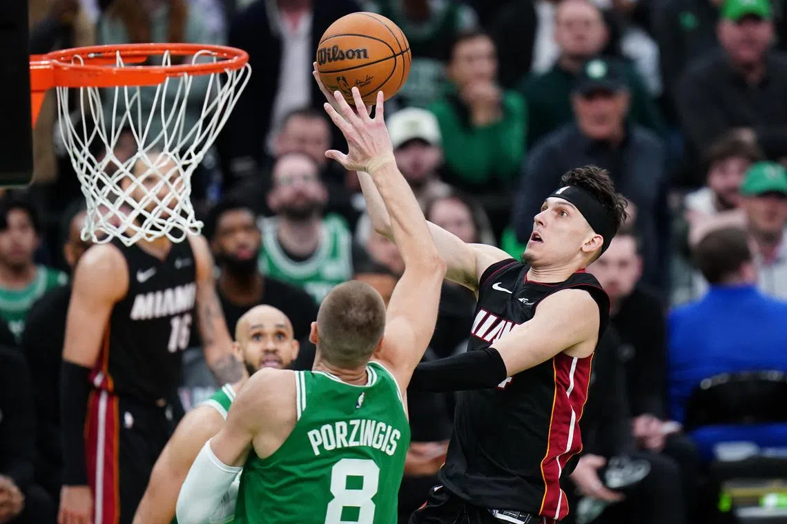 Miami Heat guard Tyler Herro drives to the basket against Boston Celtics centre Kristaps Porzingis in the second half of Game 2 of their NBA Eastern Conference first-round play-offs.
