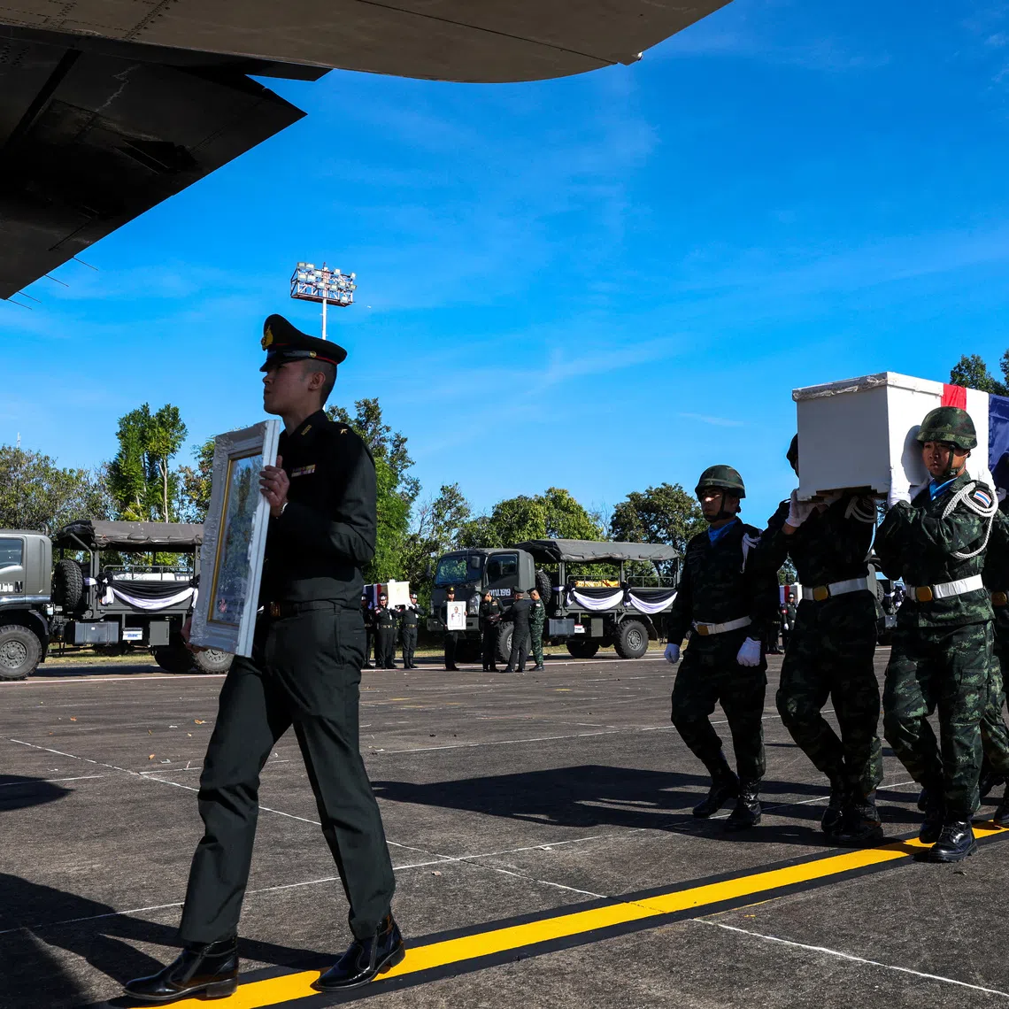Military personnel carry the coffin of Private Mustageem Chema, covered by the Thai national flag, during a procession ceremony to transport bodies to their home town, at a military airport amid deadly clashes between Thailand and Cambodia along a disputed border area, in Ubon Ratchathani province, Thailand, December 14, 2025. REUTERS/Athit Perawongmetha