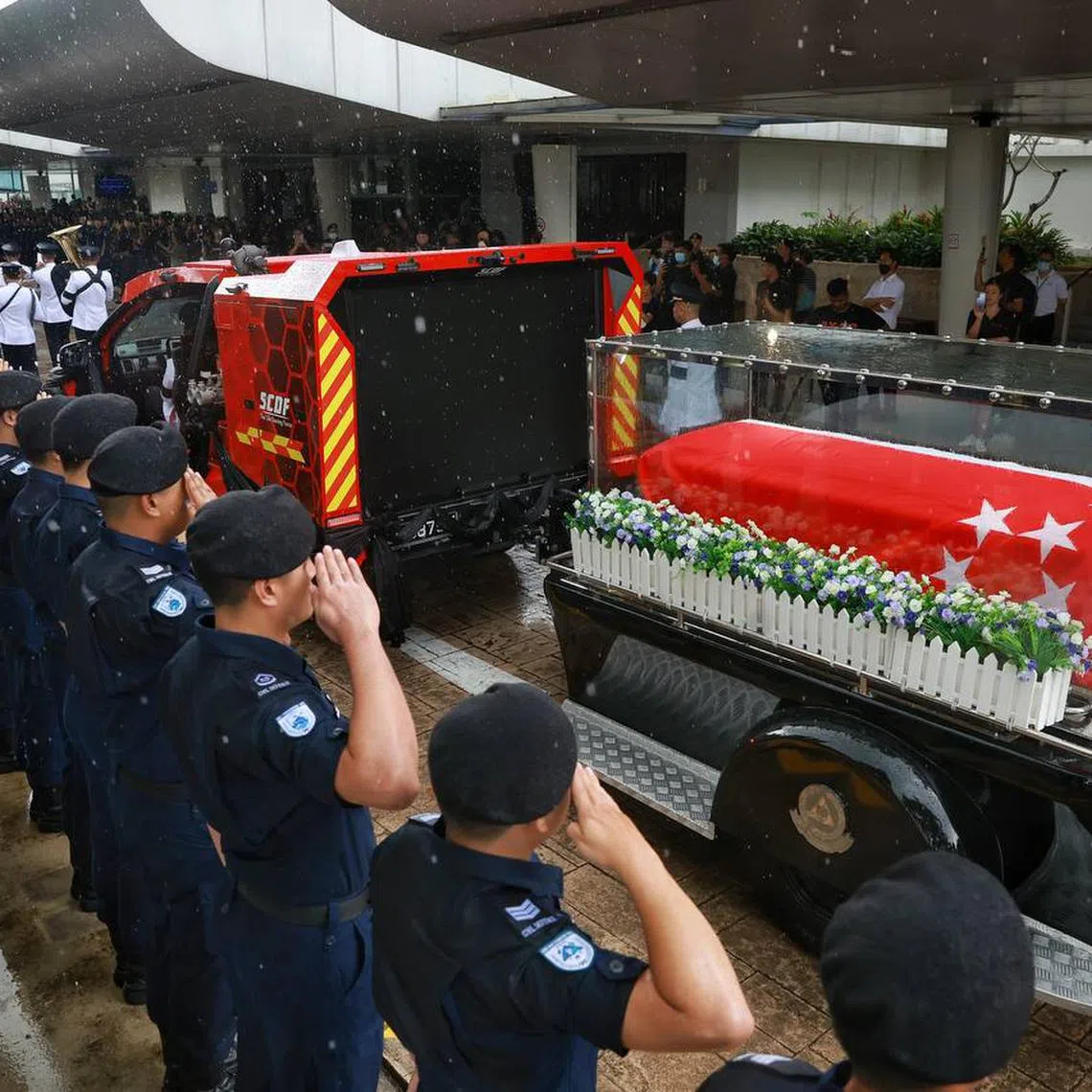SCDF personnel saluting the hearse carrying the casket of Sgt (1) Edward H. Go at Mandai Crematorium on Dec 13, 2022. 