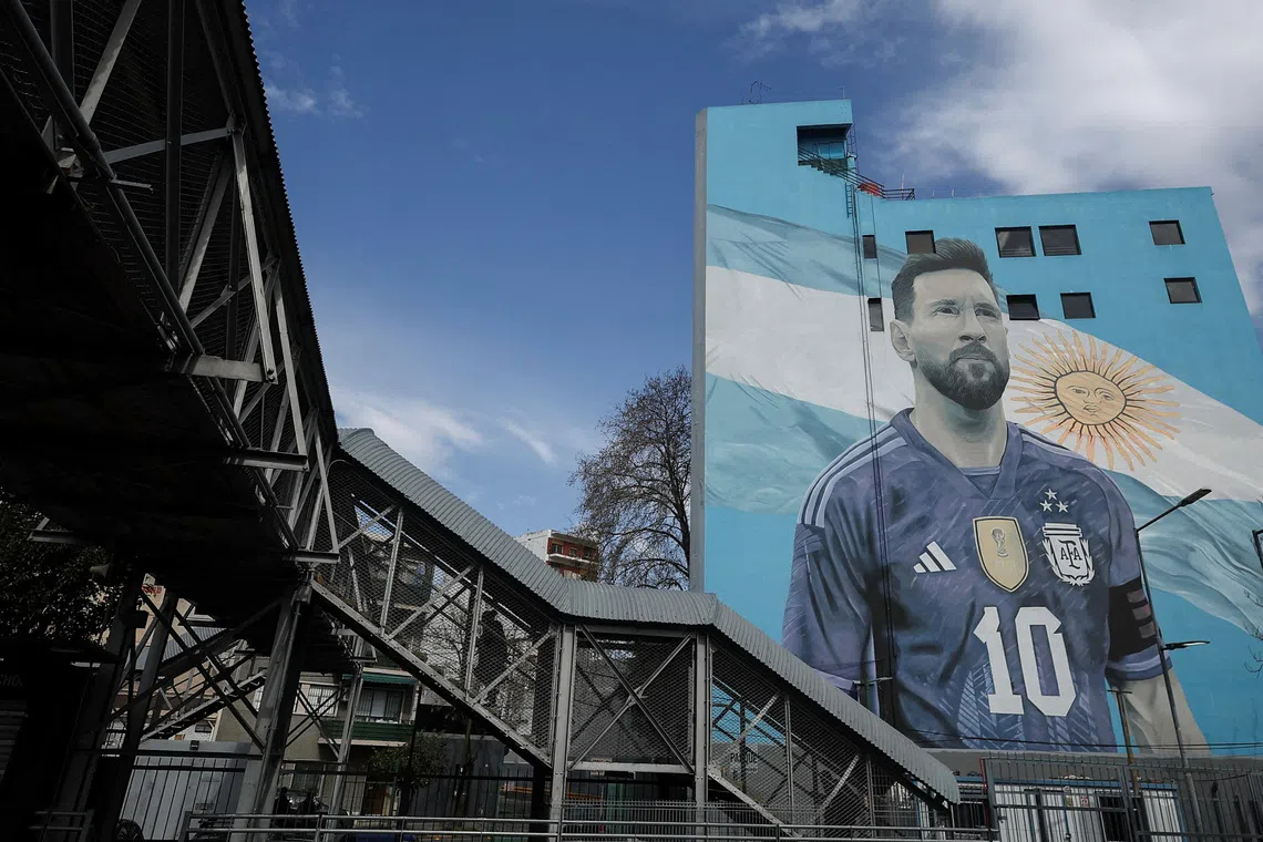 A commuter walks past a mural of Argentine soccer legend Lionel Messi, on the day he announced his retirement from the national team, at the Villa del Parque train station, in Buenos Aires, Argentina, August 31, 2026. REUTERS/Agustin Marcarian