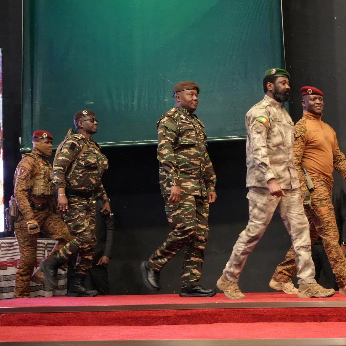 Heads of state of Mali's Assimi Goita, Burkina Faso's Captain Ibrahim Traore and Niger's General Abdourahamane Tiani walk together during the first ordinary summit of heads of state and governments of the Alliance of Sahel States (AES) in Niamey, Niger July 6, 2024. REUTERS/Mahamadou Hamidou