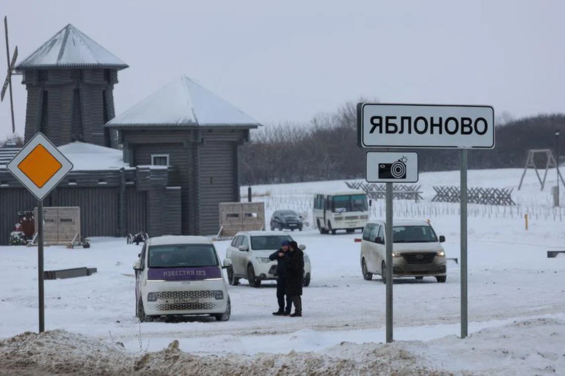 Vehicles are parked next to a road near the crash site of the Russian Ilyushin Il-76 military transport plane in the village of Yablonovo in the Belgorod region, Russia, January 25, 2024. REUTERS/Stringer