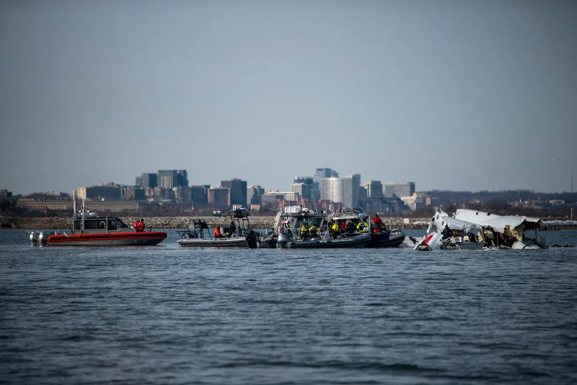 FILE PHOTO: U.S. Coast Guard, along with other search and rescue teams, operate near debris at the crash site in the Potomac River in a location given as Washington, in the aftermath of the collision of American Eagle flight 5342 and a Black Hawk helicopter that crashed into the Potomac River, U.S. January 30, 2025. Taylor Bacon/U.S. Coast Guard/Handout via REUTERS/File Photo