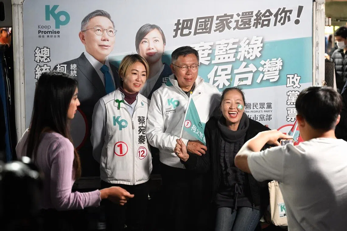 Dr Ko Wen-je, the TPP presidential candidate, taking photos with his supporters at Fuhua night market in Tainan on Jan 9, 2024.
