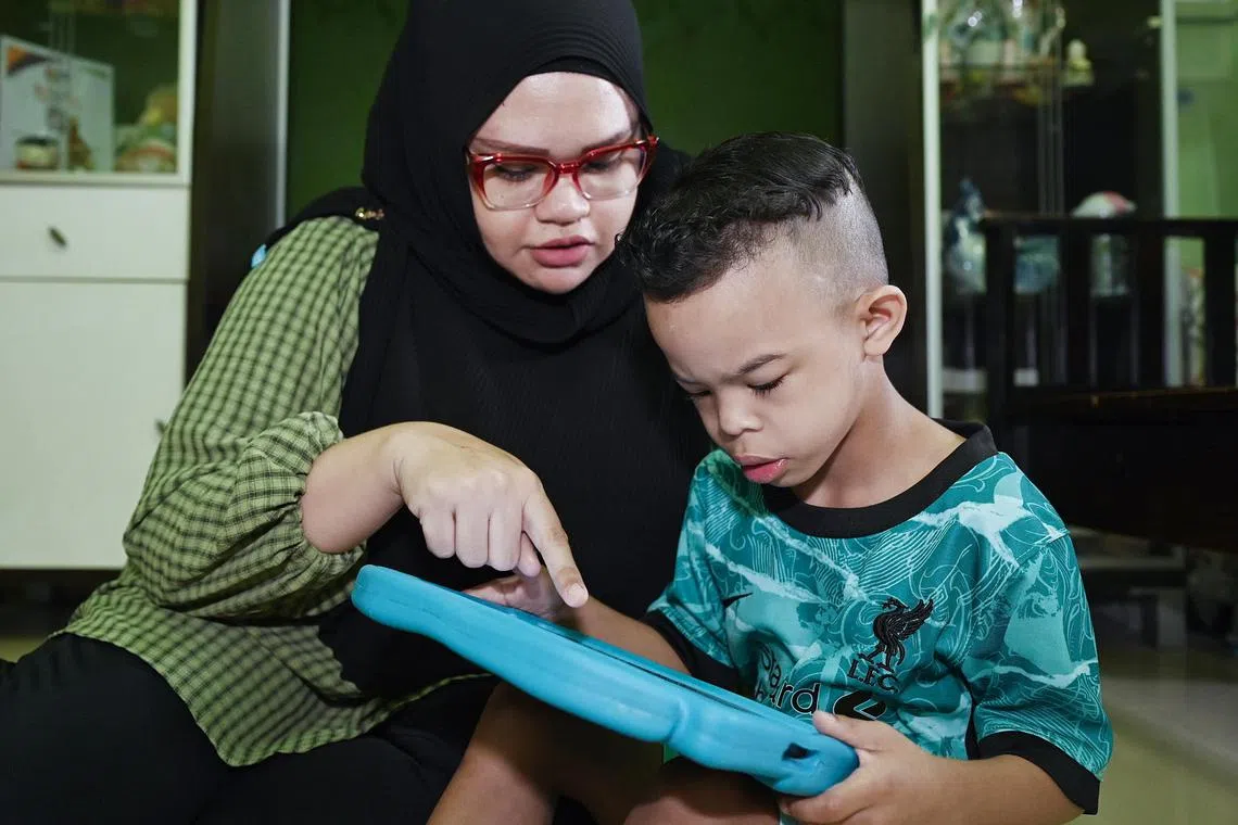 Ms Noraini Abdul Majid with her son Mohamed Syakir Nasruddinq, one of some 30 people in Singapore diagnosed with Williams Syndrome.